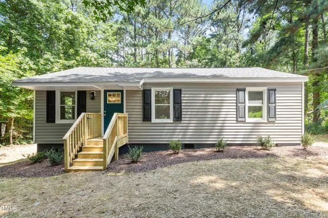 a view of house with a chairs in patio