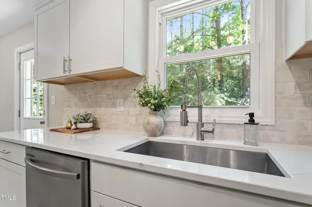 a kitchen with a sink and a window