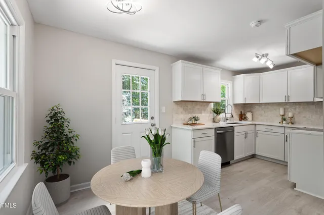 a kitchen with a potted plant in it and white countertops