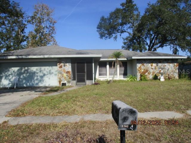 17849 Morninghigh Drive Lutz, FL 33549 - Photo 1 of 15 a front view of a house with garden
