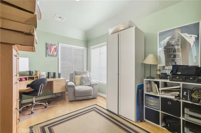 a view of a workspace with furniture and a window