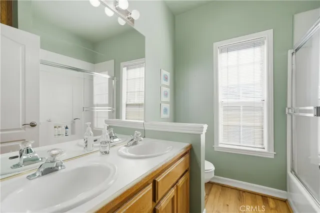 a bathroom with 2 sink tub and a mirror