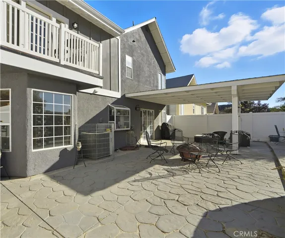 a view of a house with backyard porch and sitting area