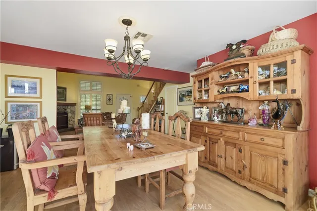 a view of a dining room with furniture and chandelier