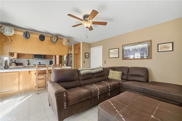 a living room with furniture and kitchen view