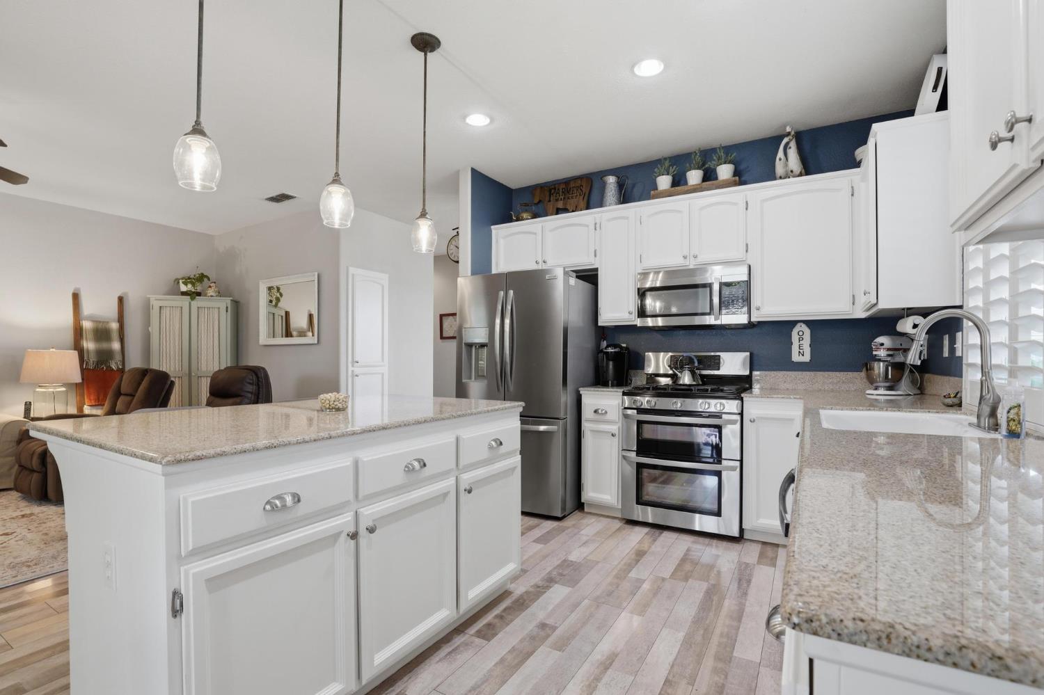 502 Waterfowl Way Williams, CA 95987 - Photo 17 of 51 a kitchen with stainless steel appliances kitchen island granite countertop a stove a sink and a refrigerator