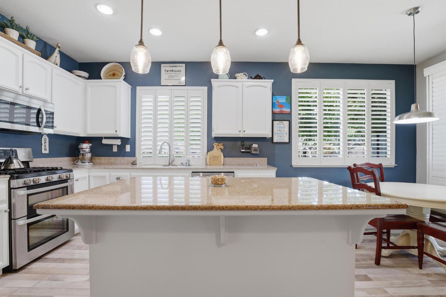502 Waterfowl Way Williams, CA 95987 - Photo 20 of 51 a kitchen with stainless steel appliances granite countertop a sink a stove and a wooden floor