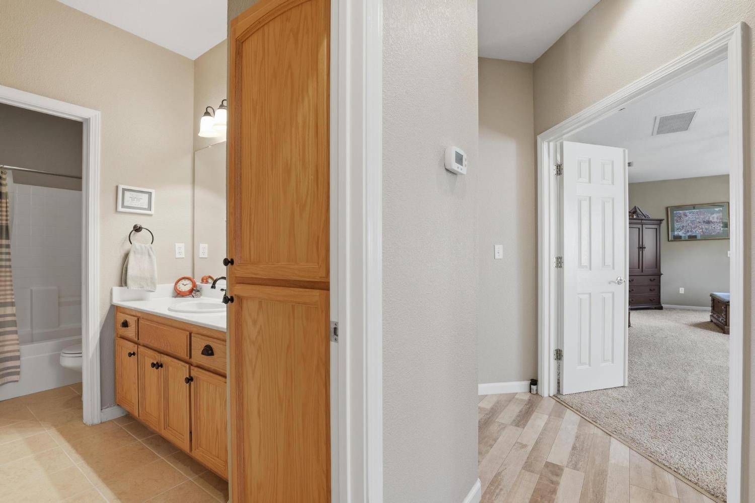 502 Waterfowl Way Williams, CA 95987 - Photo 32 of 51 a bathroom with a double vanity sink and mirror