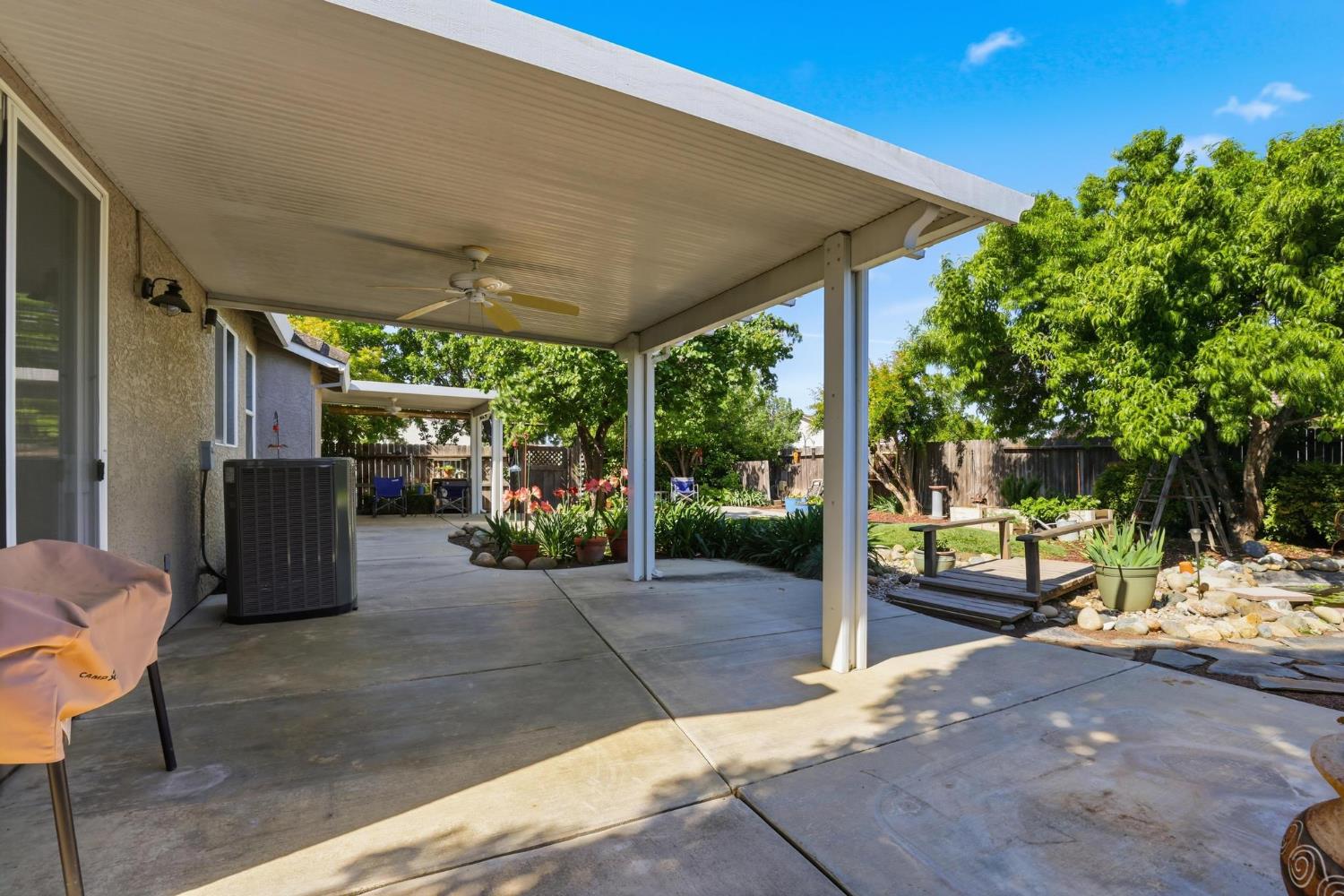 502 Waterfowl Way Williams, CA 95987 - Photo 38 of 51 a view of a patio with table and chairs potted plants and floor to ceiling window