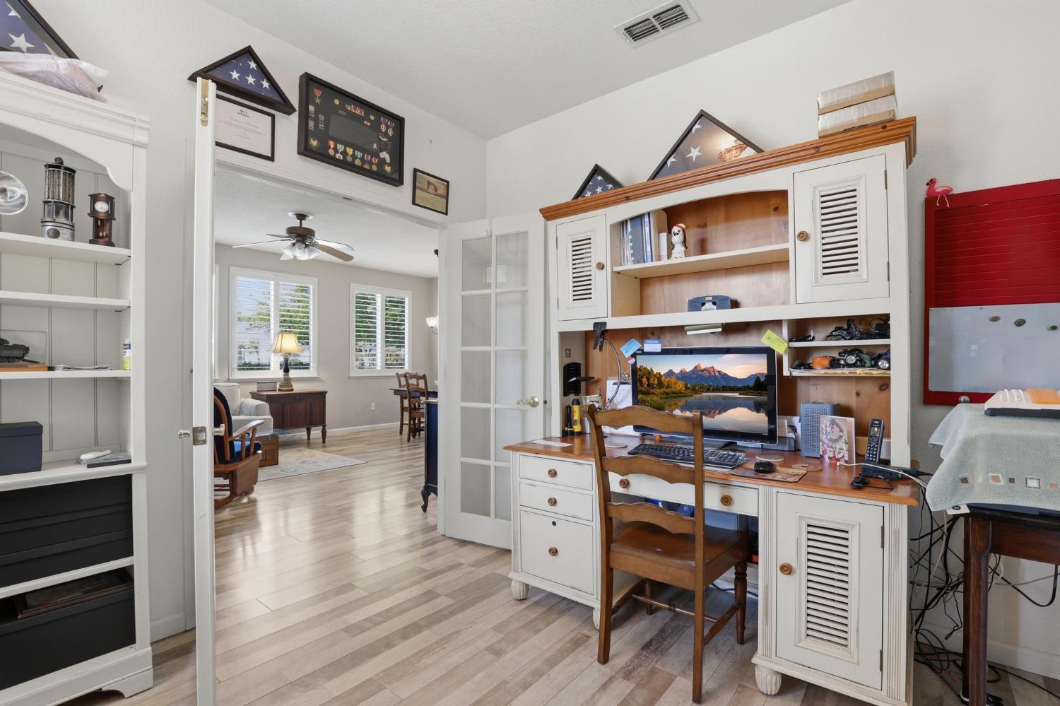 502 Waterfowl Way Williams, CA 95987 - Photo 7 of 51 a workspace with furniture wooden floor and a book shelf