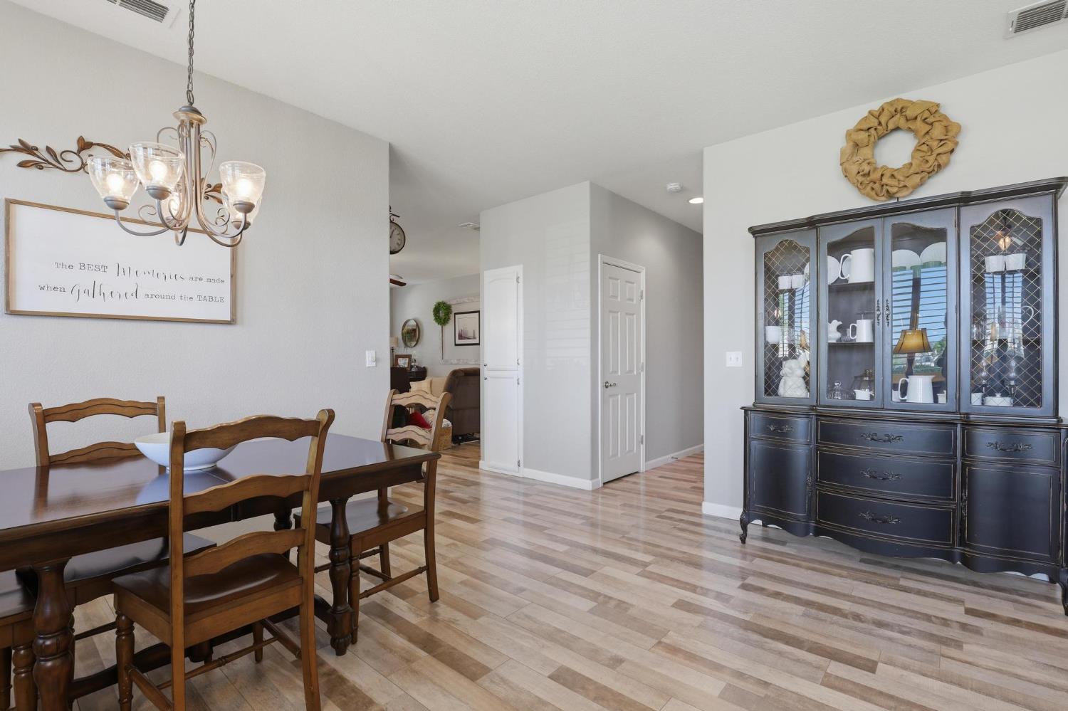 502 Waterfowl Way Williams, CA 95987 - Photo 10 of 51 a view of a dining room and livingroom with furniture wooden floor a chandelier