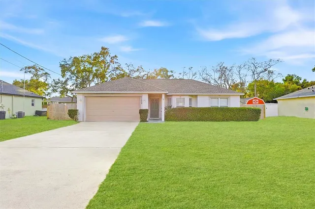 a front view of a house with a garden and yard