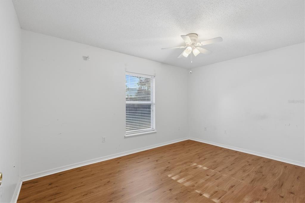 7172 Toledo Road Spring Hill, FL 34606 - Photo 12 of 38 an empty room with a window and ceiling fan