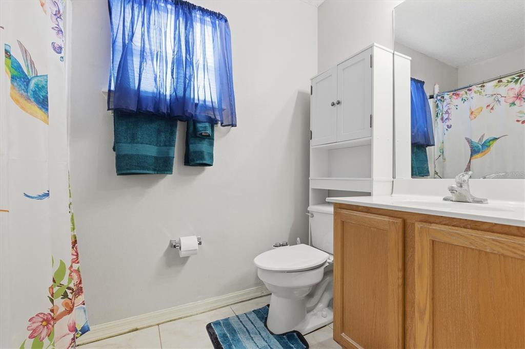 7172 Toledo Road Spring Hill, FL 34606 - Photo 14 of 38 a bathroom with a sink toilet and shower