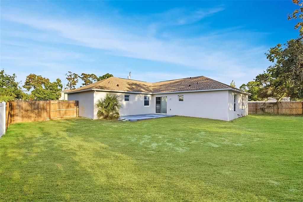 7172 Toledo Road Spring Hill, FL 34606 - Photo 16 of 38 a view of a house with a garden