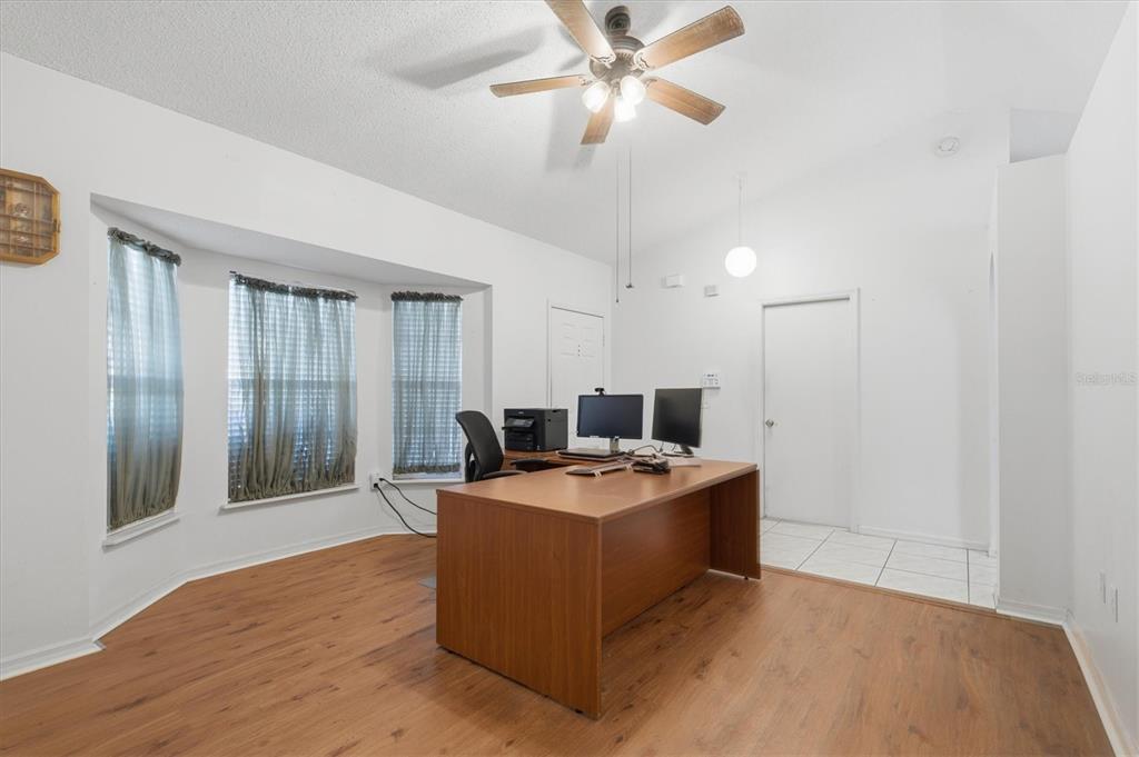 7172 Toledo Road Spring Hill, FL 34606 - Photo 18 of 38 a view of a room with kitchen island stainless steel appliances wooden floor and window