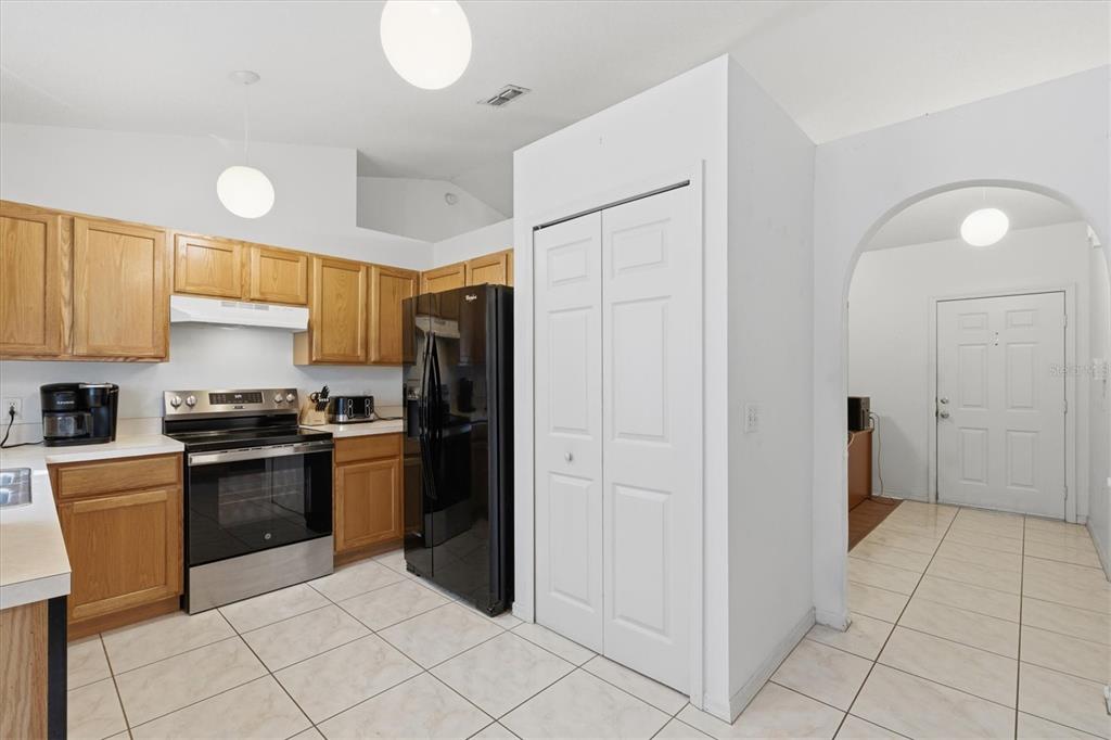 7172 Toledo Road Spring Hill, FL 34606 - Photo 20 of 38 a kitchen with stainless steel appliances granite countertop a refrigerator and a stove top oven