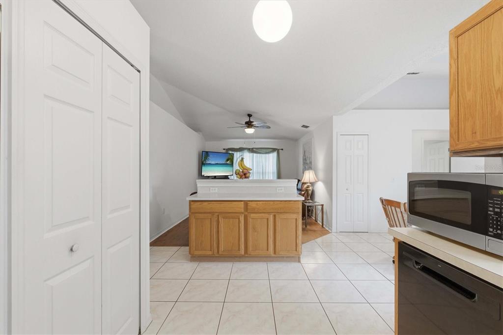 7172 Toledo Road Spring Hill, FL 34606 - Photo 22 of 38 a kitchen with granite countertop a sink cabinets and stainless steel appliances