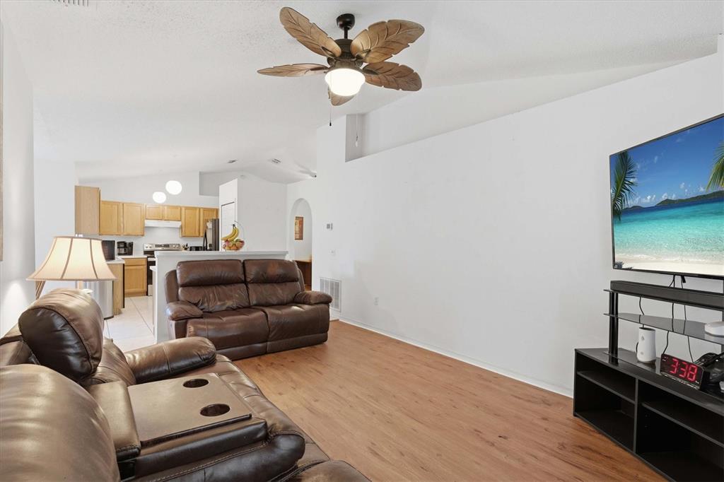 7172 Toledo Road Spring Hill, FL 34606 - Photo 25 of 38 a living room with furniture and a wooden floor