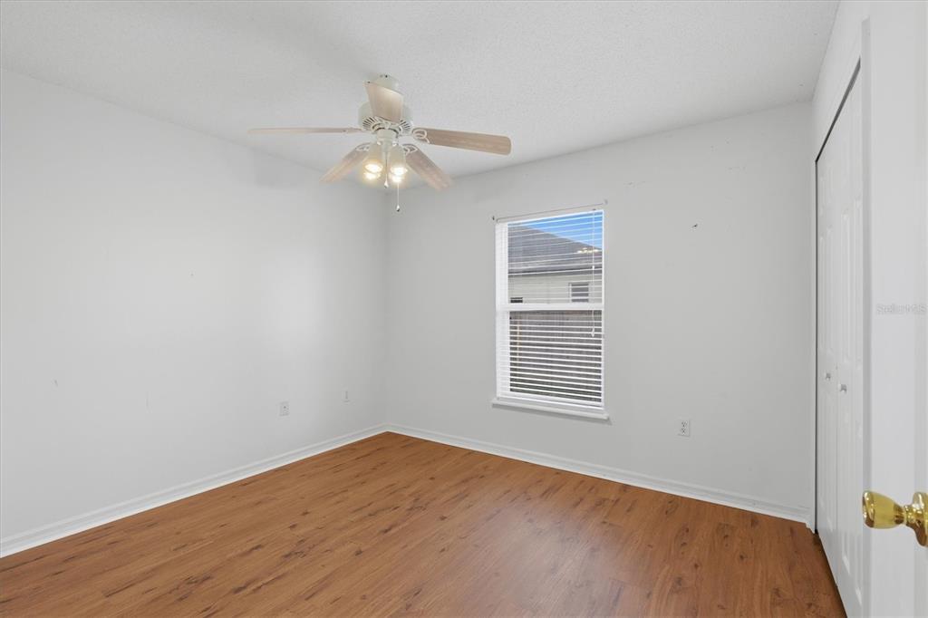 7172 Toledo Road Spring Hill, FL 34606 - Photo 26 of 38 wooden floor in an empty room with a window