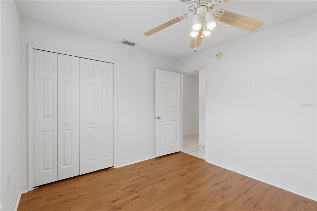 7172 Toledo Road Spring Hill, FL 34606 - Photo 27 of 38 a view of empty room with window and wooden floor