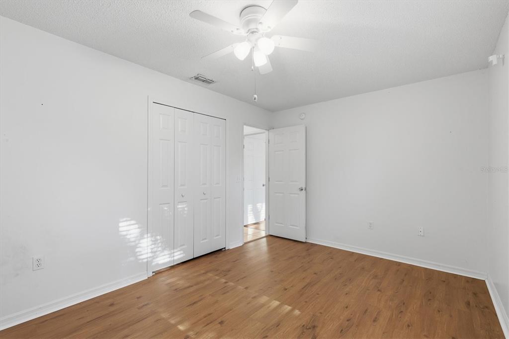 7172 Toledo Road Spring Hill, FL 34606 - Photo 28 of 38 a view of an empty room and chandelier fan
