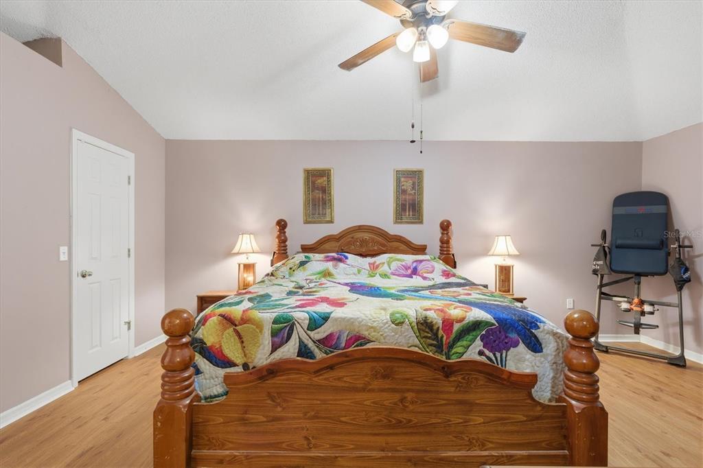 7172 Toledo Road Spring Hill, FL 34606 - Photo 29 of 38 a bedroom with a bed and wooden floor