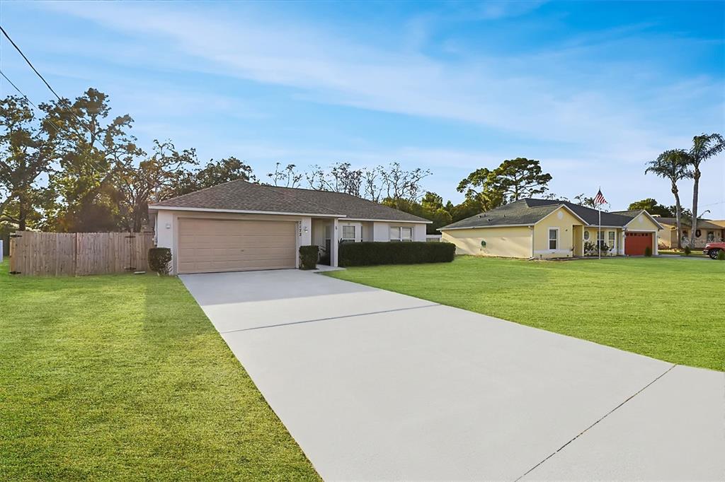 7172 Toledo Road Spring Hill, FL 34606 - Photo 31 of 38 a house view with a garden space