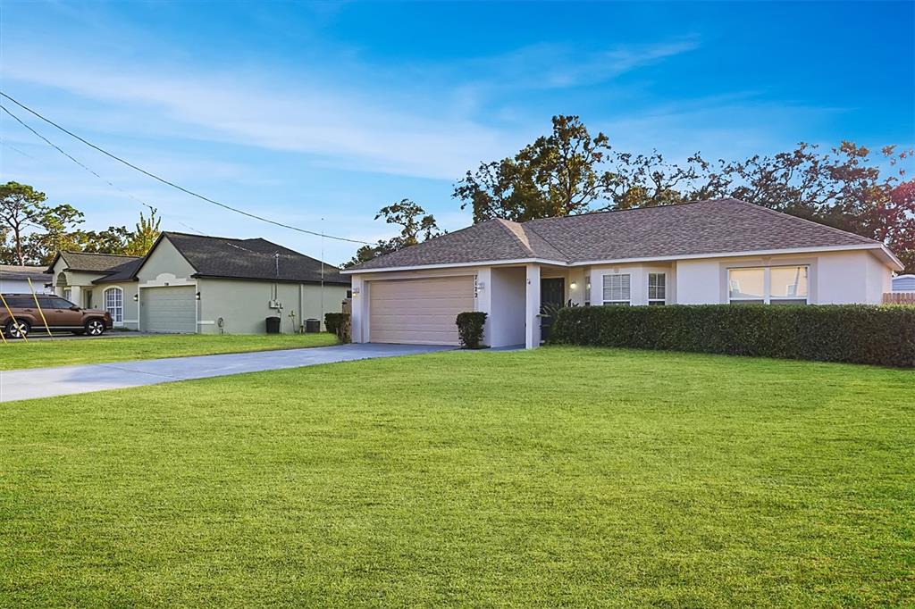 7172 Toledo Road Spring Hill, FL 34606 - Photo 35 of 38 a front view of a house with a garden
