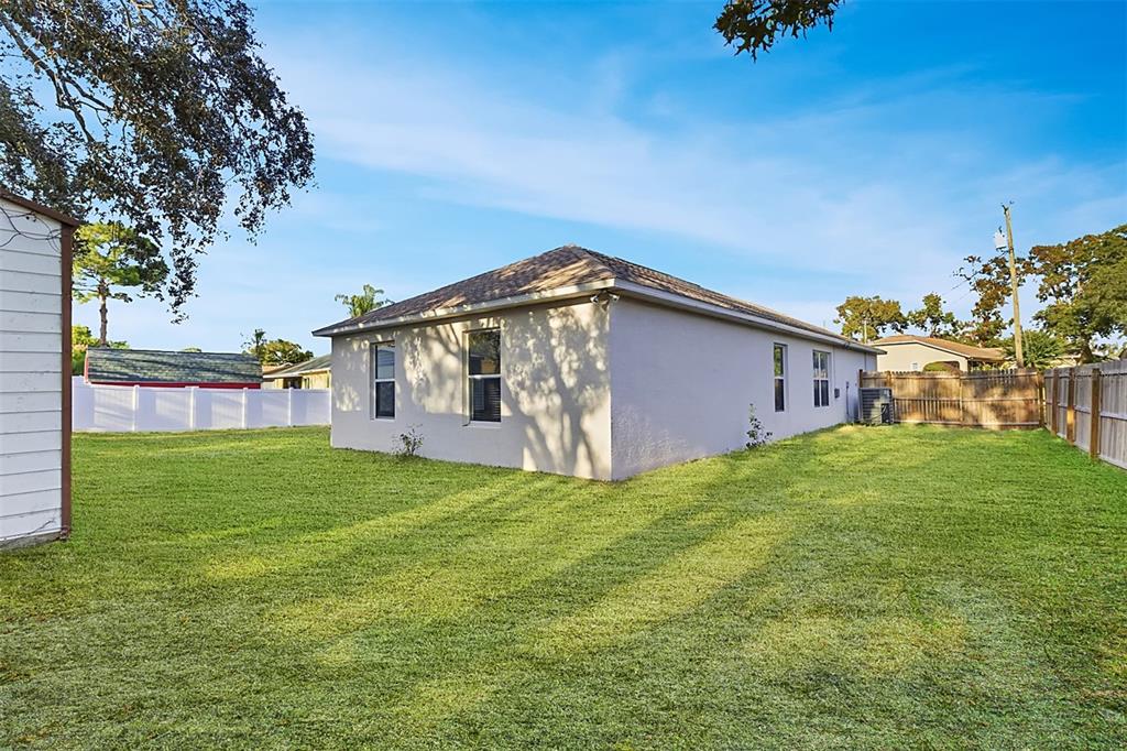 7172 Toledo Road Spring Hill, FL 34606 - Photo 36 of 38 a view of a house with backyard and garden
