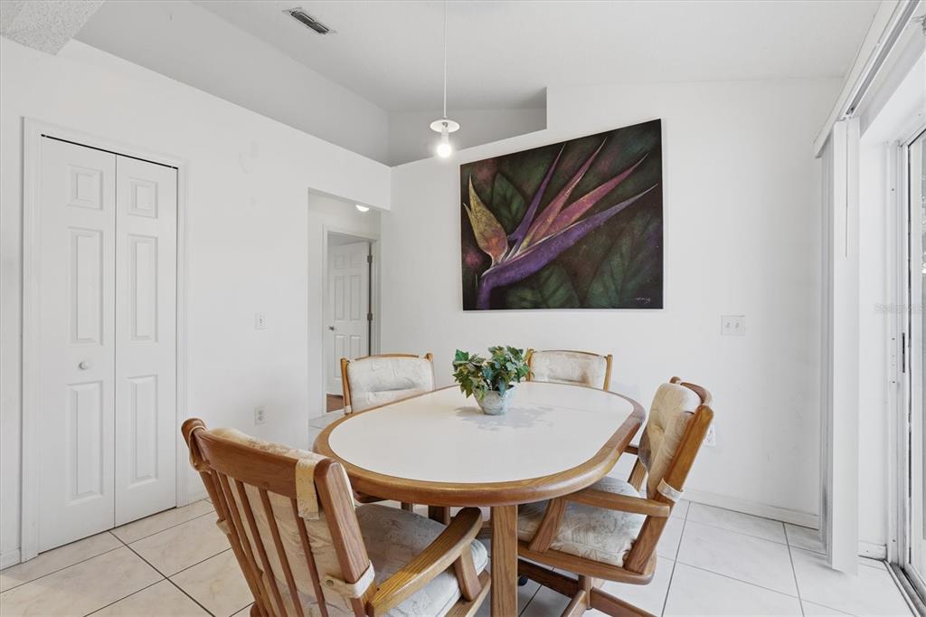 7172 Toledo Road Spring Hill, FL 34606 - Photo 7 of 38 a dining room with furniture and wooden floor