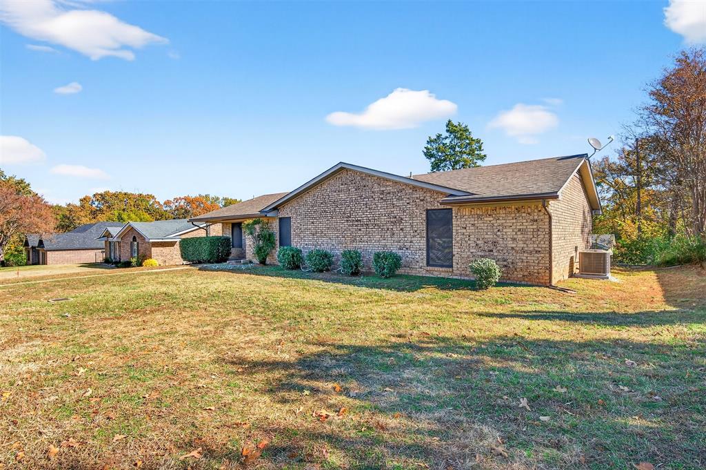 3014 Jennifer Avenue Denison, TX 75020 - Photo 2 of 23 a front view of house with yard and trees in the background