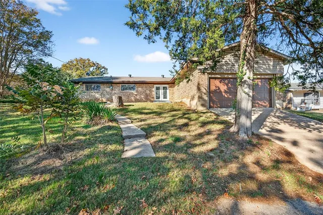 a view of a house with a tree in a yard