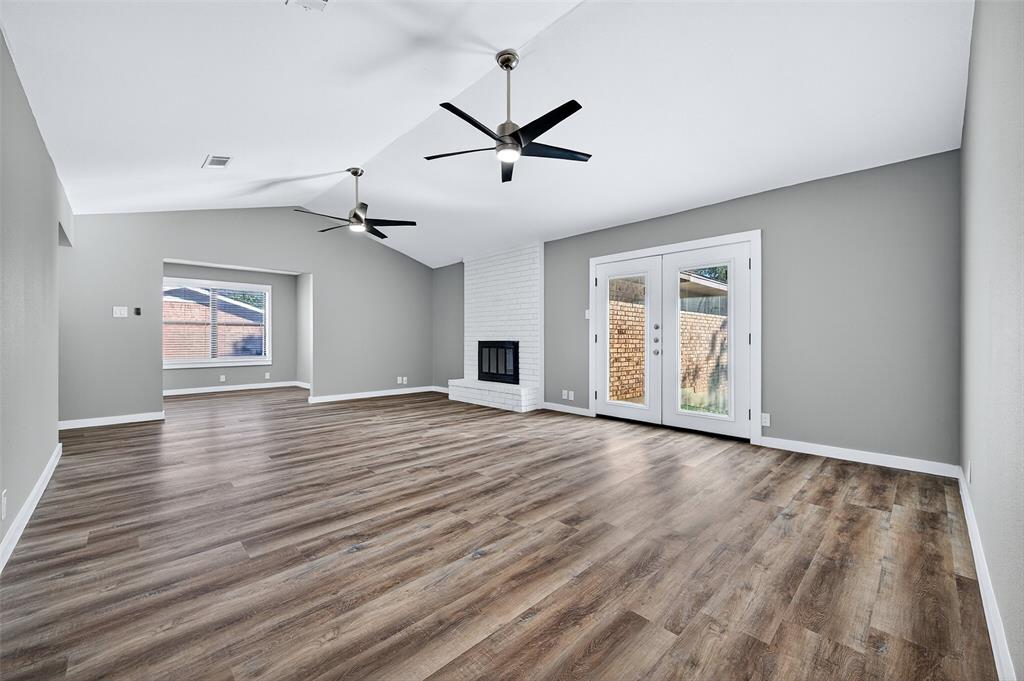 3014 Jennifer Avenue Denison, TX 75020 - Photo 5 of 23 an empty room with wooden floor ceiling fan and windows