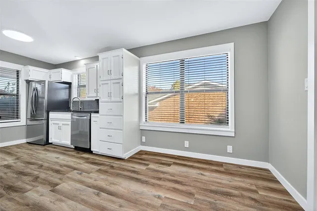 a view of a kitchen with refrigerator and cabinet