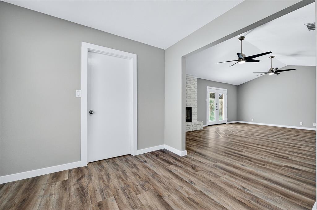 3014 Jennifer Avenue Denison, TX 75020 - Photo 7 of 23 a view of a livingroom with wooden floor and a ceiling fan