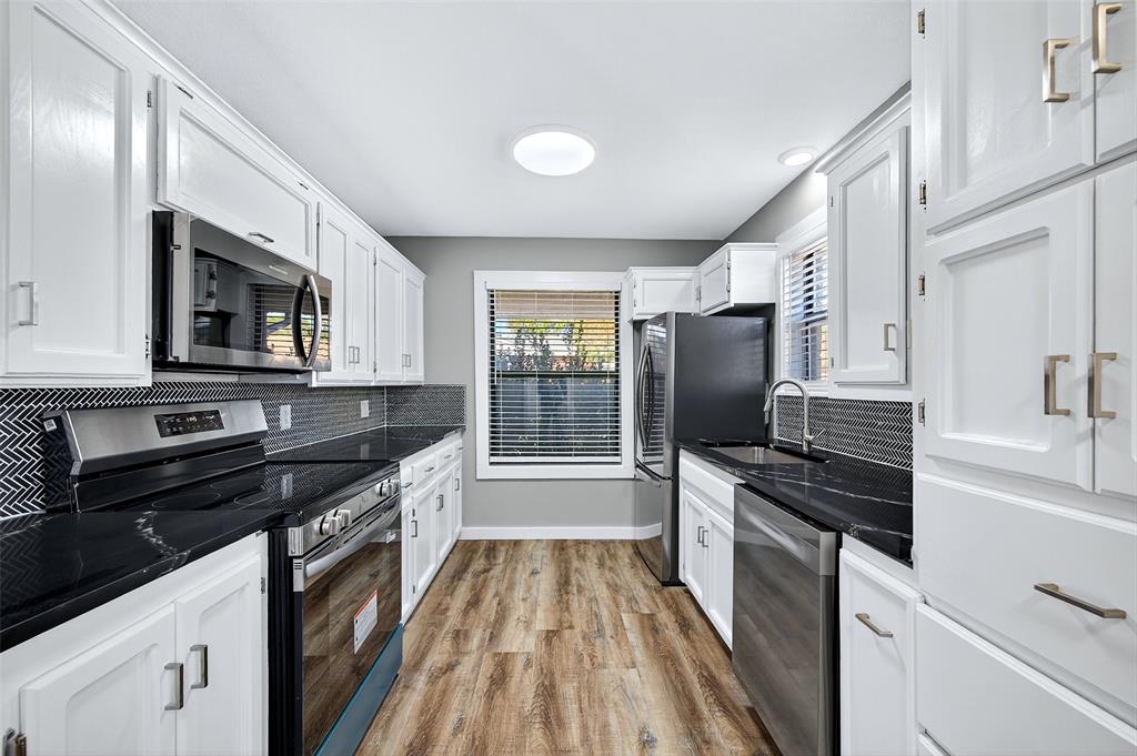 3014 Jennifer Avenue Denison, TX 75020 - Photo 8 of 23 a kitchen with granite countertop a stove sink and microwave