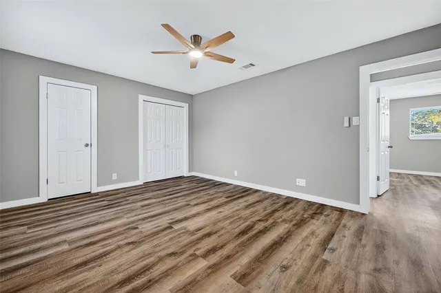 a view of a livingroom with wooden floor and white walls