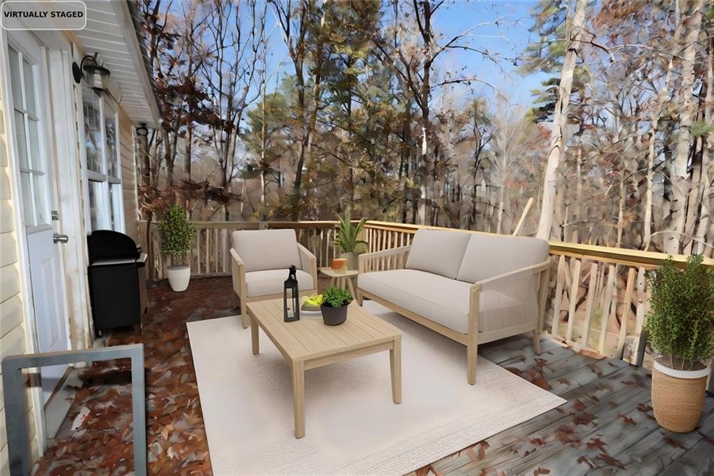 34 Clay Court Villa Rica, GA 30180 - Photo 14 of 15 a view of a patio with couches and a table and chairs with wooden floor