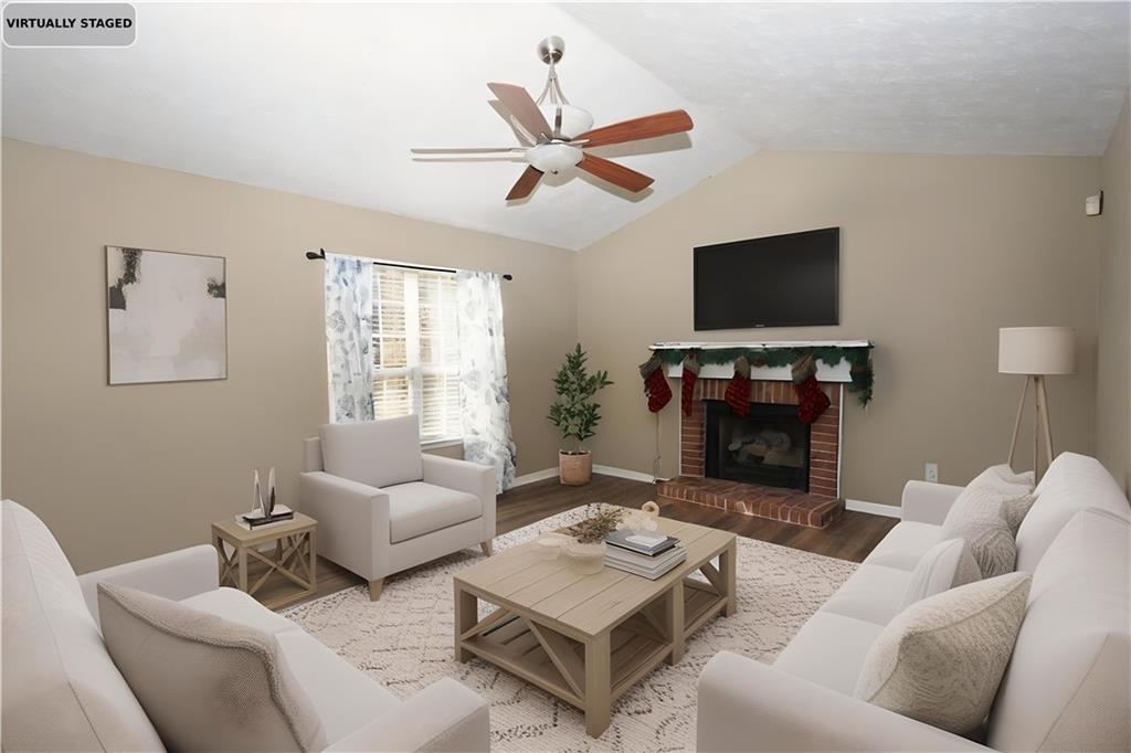 34 Clay Court Villa Rica, GA 30180 - Photo 4 of 15 a living room with furniture a flat screen tv and a fireplace