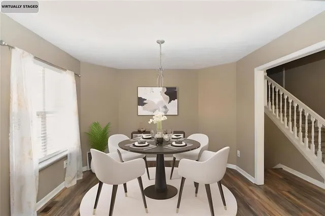 a dining room with furniture a rug and wooden floor
