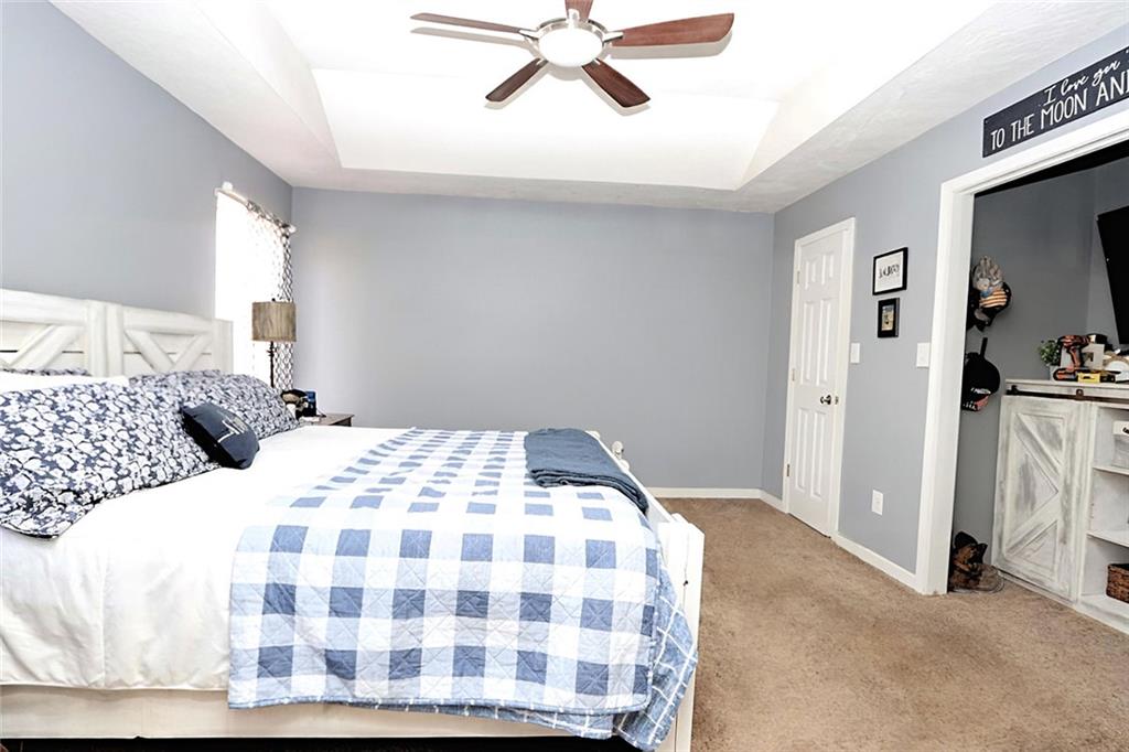 34 Clay Court Villa Rica, GA 30180 - Photo 7 of 15 a bedroom with a bed and a chandelier