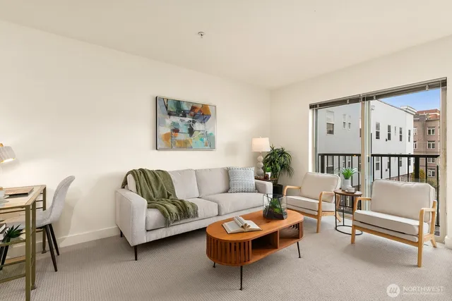 a living room with furniture a rug and a wall painting