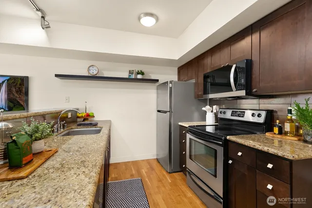 a kitchen with stainless steel appliances granite countertop a stove and a sink