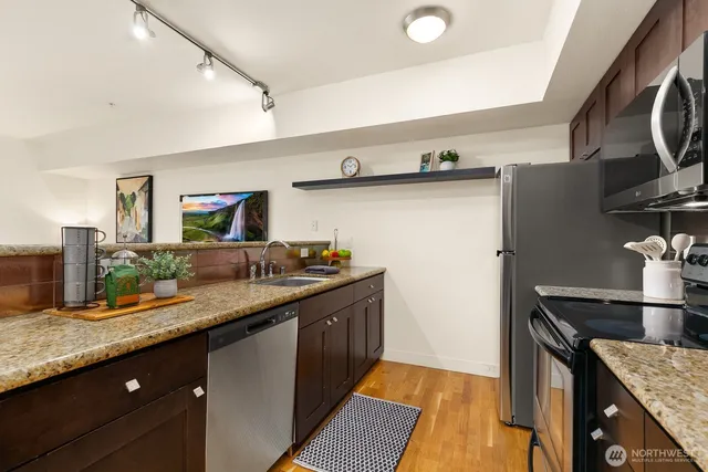a kitchen with granite countertop a sink and a stove