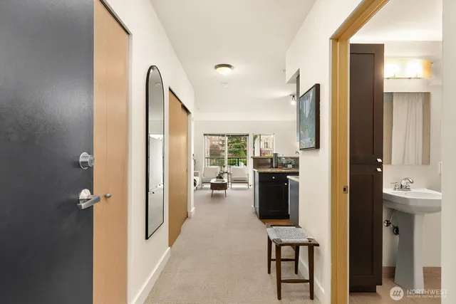 a view of a hallway with living room and dining room