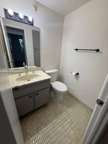 a bathroom with a sink toilet and mirror