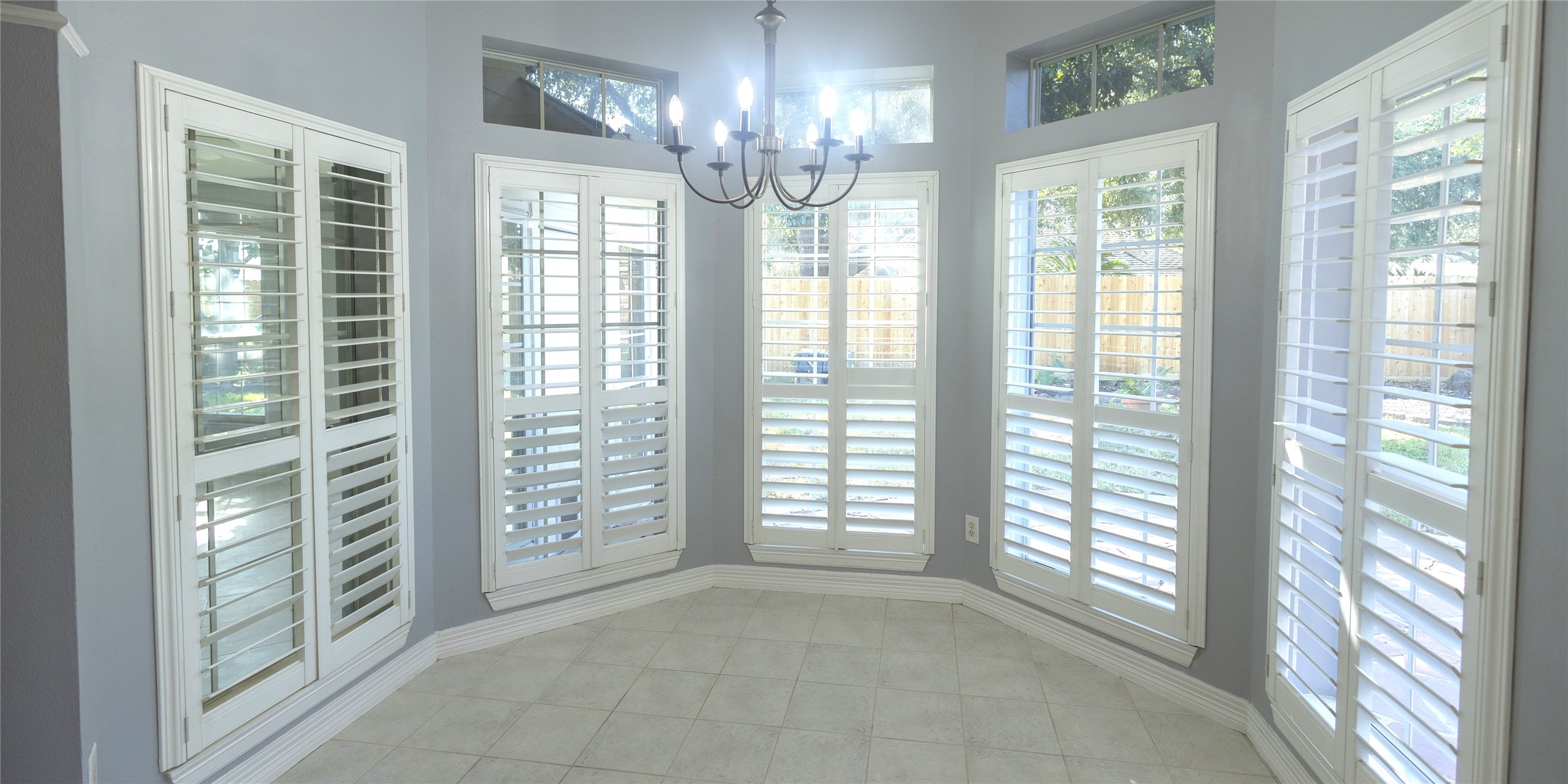 4402 Prince Pine Trail Houston, TX 77059 - Photo 11 of 23 a view of an empty room with windows and chandelier