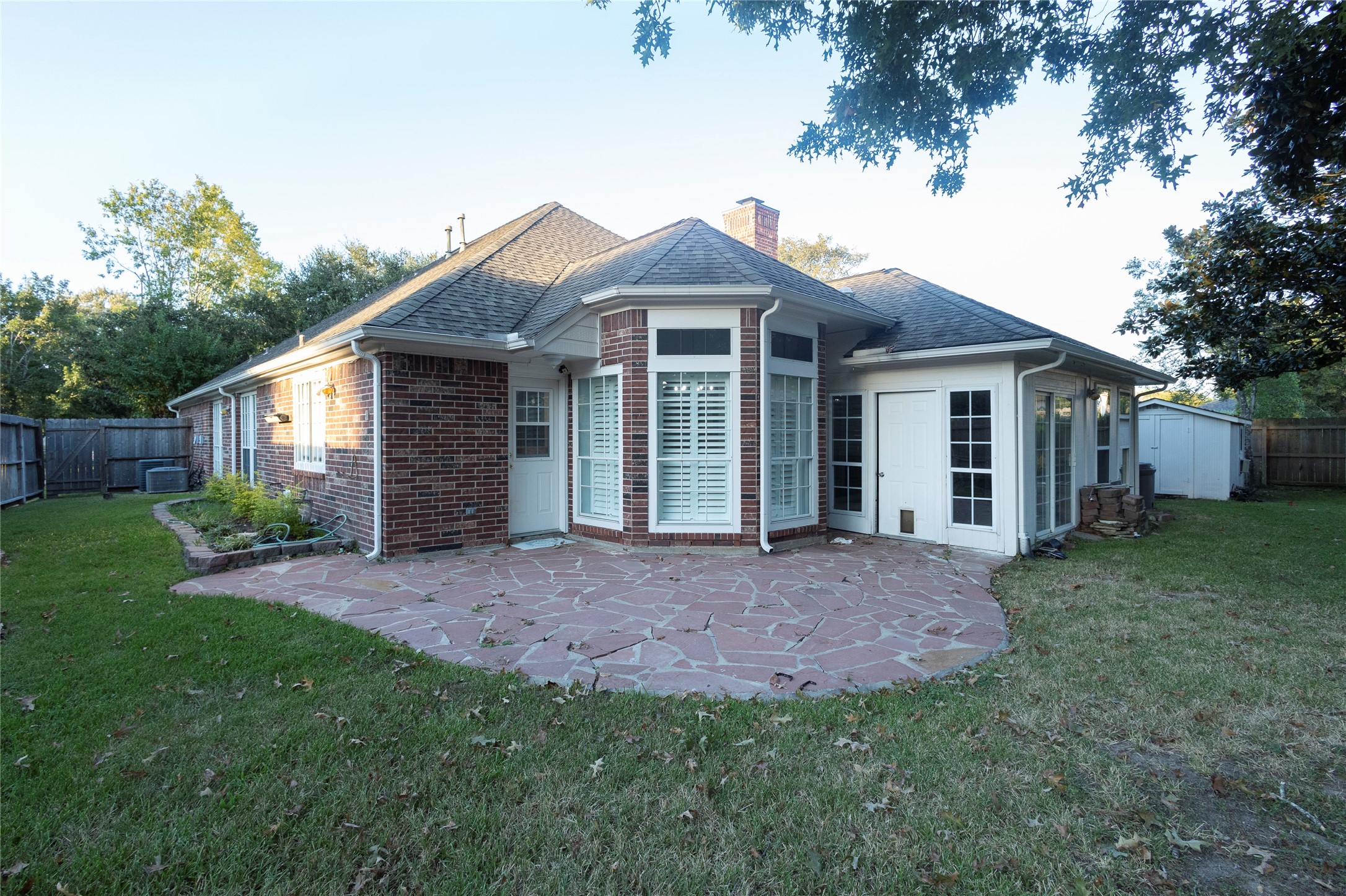 4402 Prince Pine Trail Houston, TX 77059 - Photo 21 of 23 a view of a yard in front of a house with plants and large tree