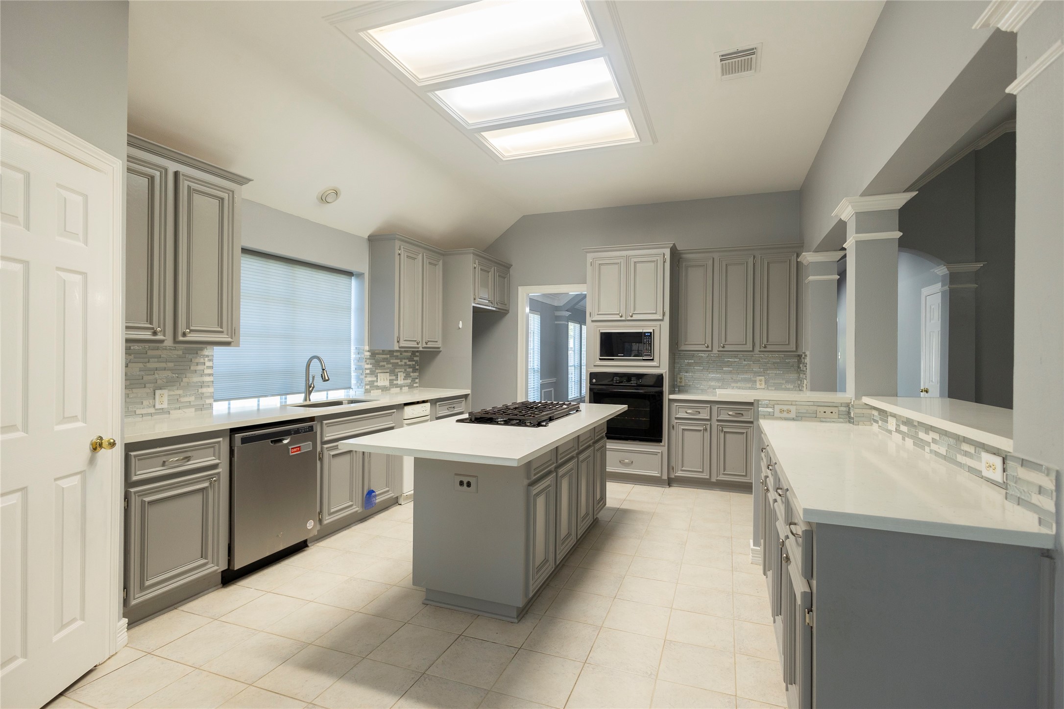 4402 Prince Pine Trail Houston, TX 77059 - Photo 10 of 23 a large kitchen with a stove top oven sink and cabinets